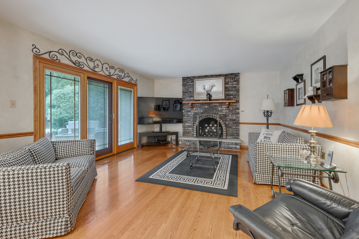 13031 Winnebago Road Palos Heights, IL 60463 - Photo 10 of 31 a living room with furniture and a fireplace