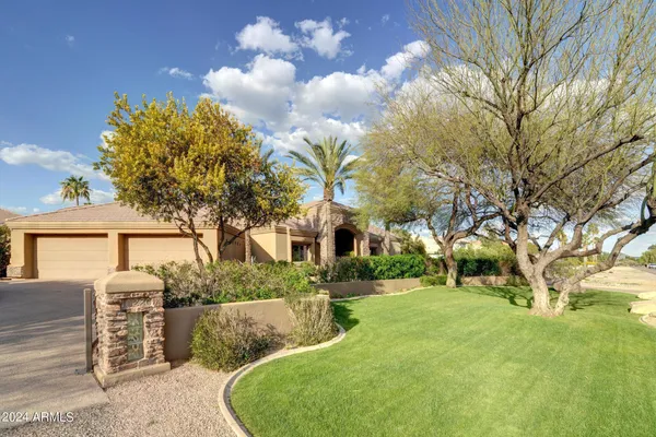 a view of a house with a backyard