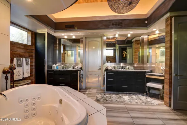a kitchen with stainless steel appliances kitchen island granite countertop cabinets and a wooden floor
