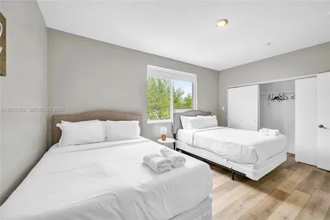 a bedroom with a bed and a painting on the wall