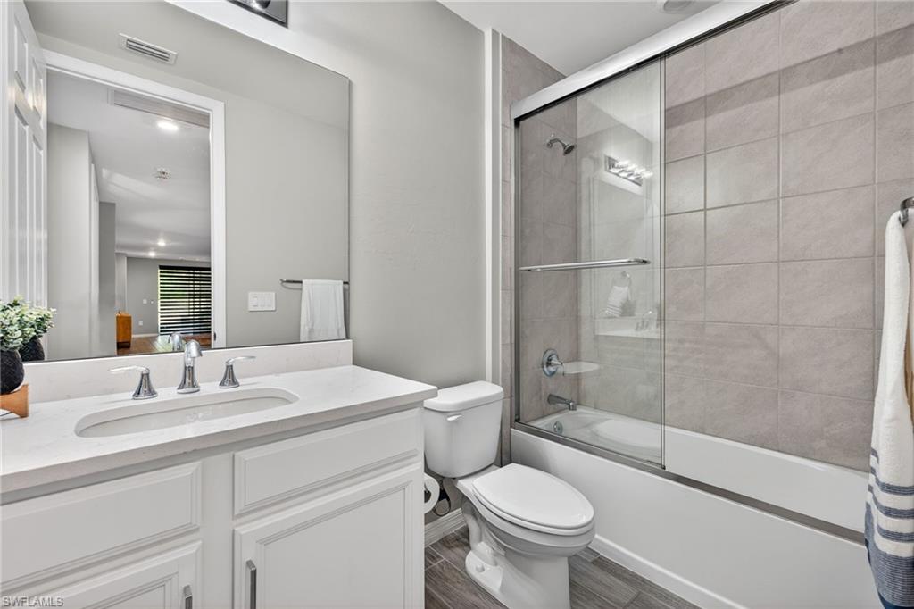 14567 Edgewater Circle Naples, FL 34114 - Photo 25 of 43 a bathroom with a sink toilet and shower