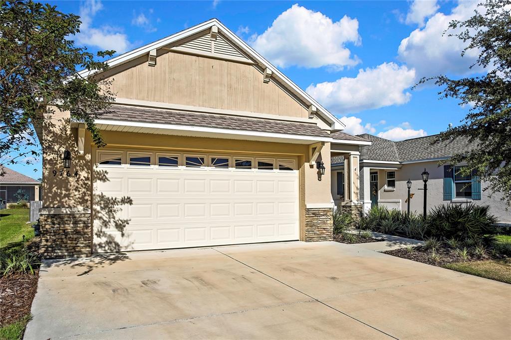 a view of house with yard and parking