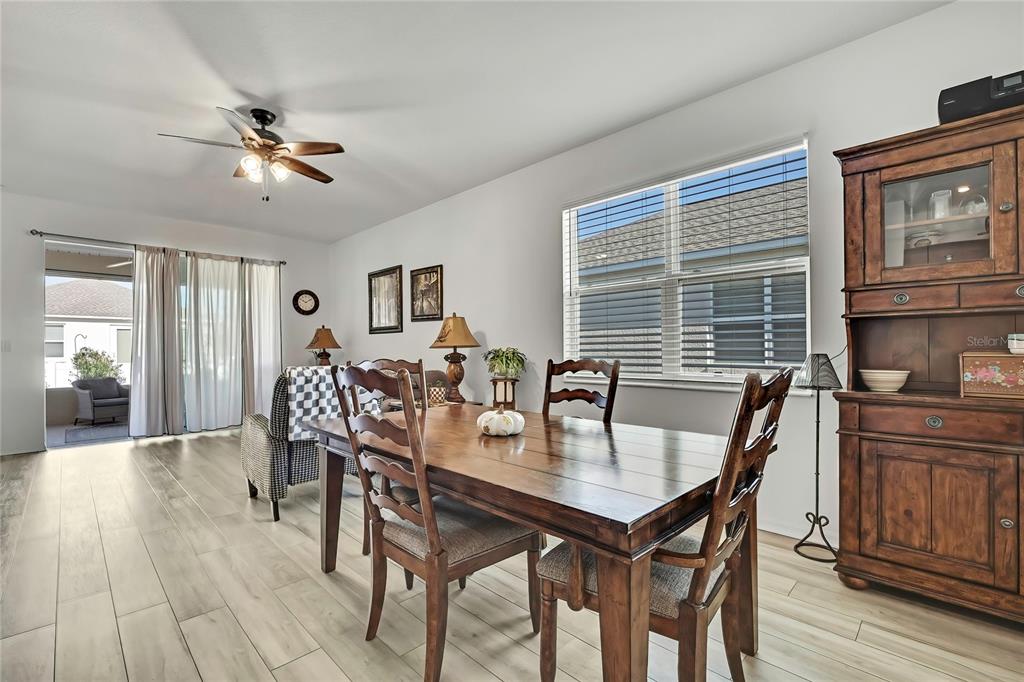 9764 Southwest 100th Avenue Ocala, FL 34481 - Photo 13 of 37 a view of a dining room with furniture window and wooden floor