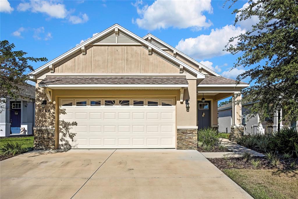 9764 Southwest 100th Avenue Ocala, FL 34481 - Photo 2 of 37 a front view of a house with a yard and garage