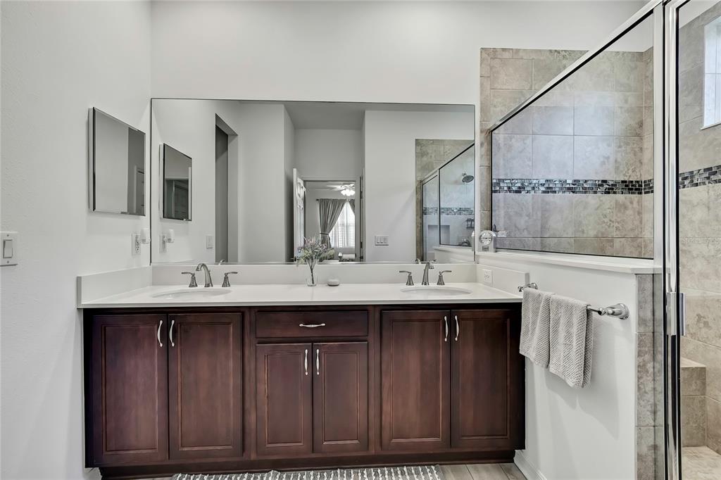 9764 Southwest 100th Avenue Ocala, FL 34481 - Photo 21 of 37 a bathroom with a double vanity sink and mirror