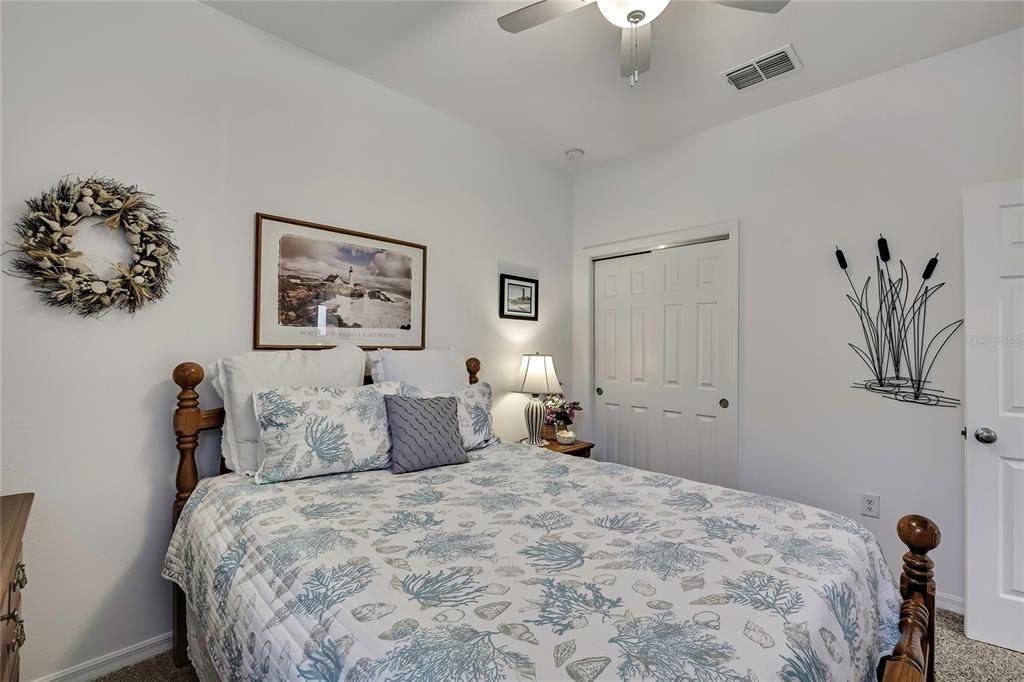 9764 Southwest 100th Avenue Ocala, FL 34481 - Photo 24 of 37 a bedroom with a bed and a painting on the wall