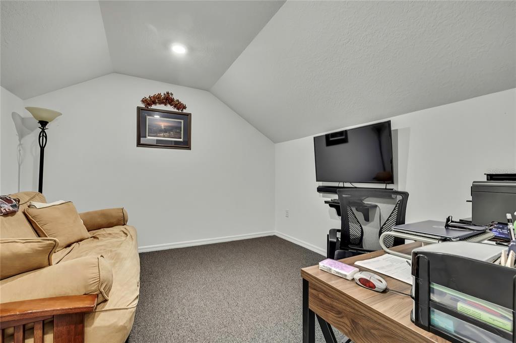 9764 Southwest 100th Avenue Ocala, FL 34481 - Photo 28 of 37 a room with furniture and a flat screen tv