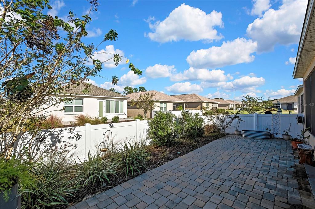 9764 Southwest 100th Avenue Ocala, FL 34481 - Photo 33 of 37 a front view of a house with a yard and balcony