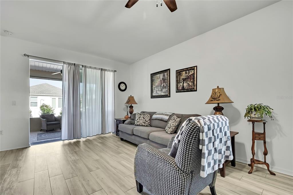 9764 Southwest 100th Avenue Ocala, FL 34481 - Photo 9 of 37 a bedroom with a bed and wooden floor