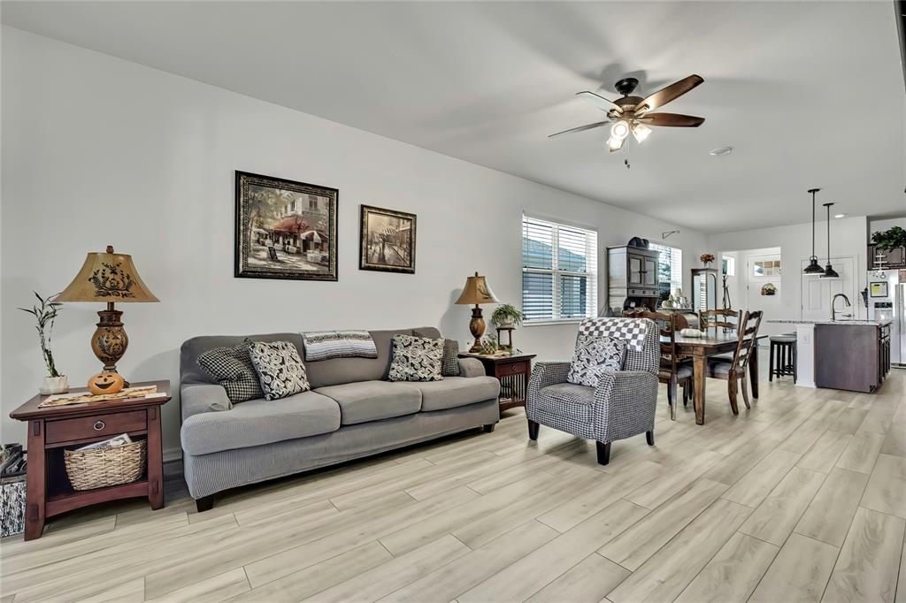 9764 Southwest 100th Avenue Ocala, FL 34481 - Photo 10 of 37 a living room with furniture and a wooden floor