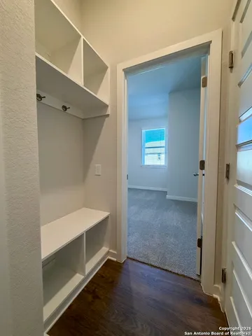 a view of a room with wooden floor and window