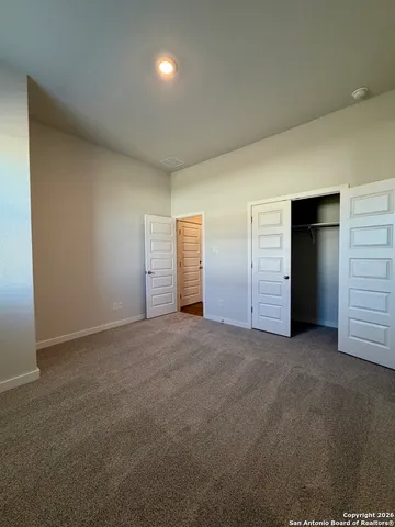a kitchen with granite countertop white cabinets and stainless steel appliances