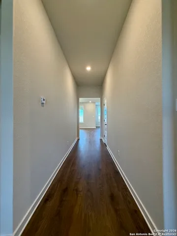 an empty room with windows and ceiling fan view