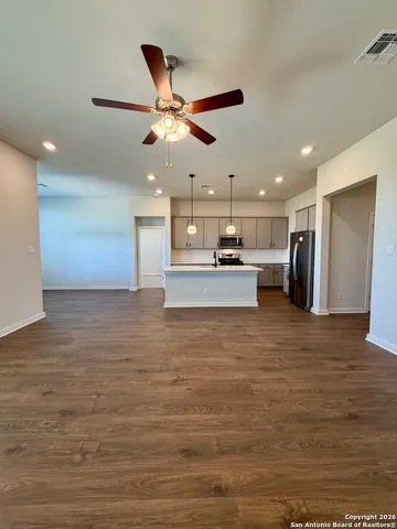 a bathroom with a glass door shower a sink and a toilet