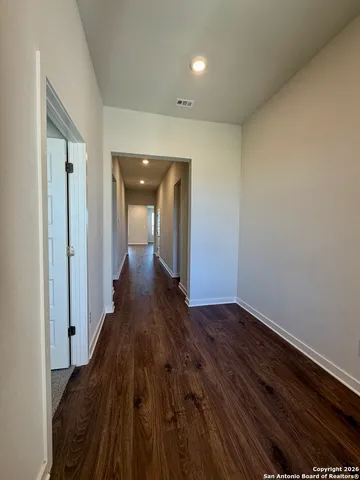 an empty room with closet and mirrors