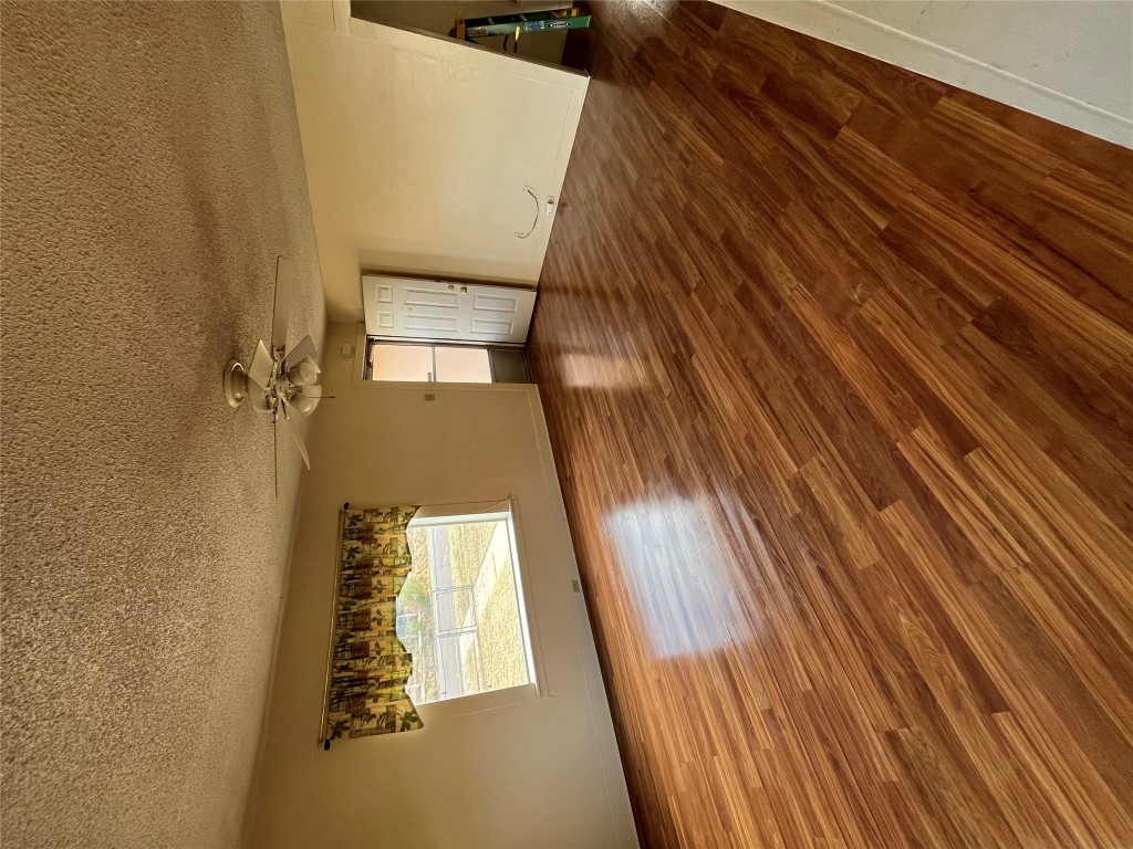 608 South Bell Street Big Spring, TX 79720 - Photo 4 of 11 a view of empty room with wooden floor and fan