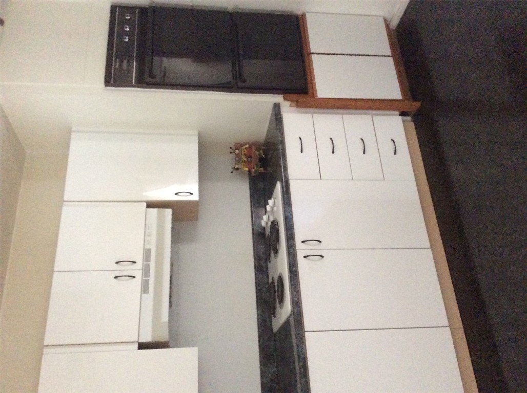 608 South Bell Street Big Spring, TX 79720 - Photo 5 of 11 a kitchen with white cabinets and sink