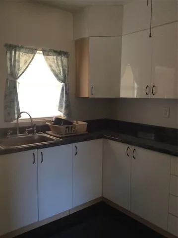 a close view of sink and cabinets