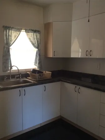 a close view of sink and cabinets