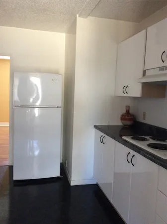 a kitchen with a refrigerator and a stove