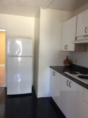 a kitchen with a refrigerator and a stove