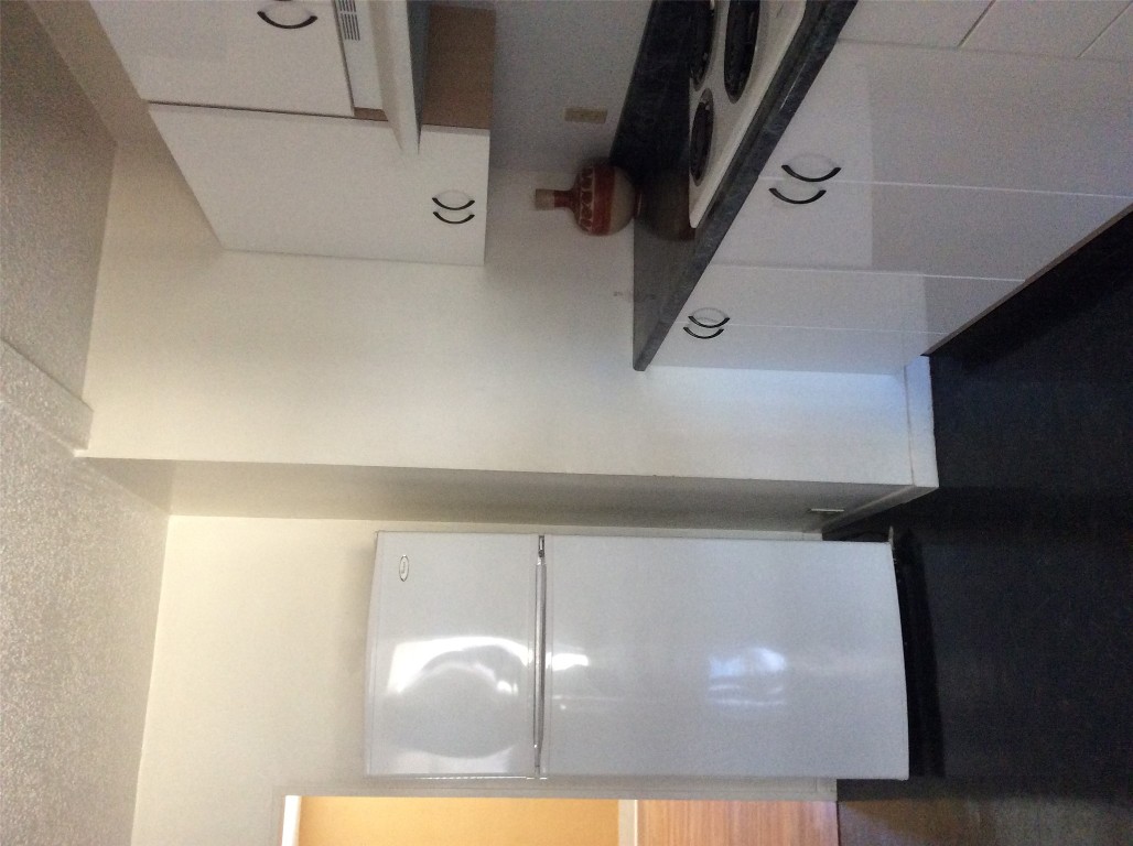 608 South Bell Street Big Spring, TX 79720 - Photo 9 of 11 a kitchen with a refrigerator and a stove