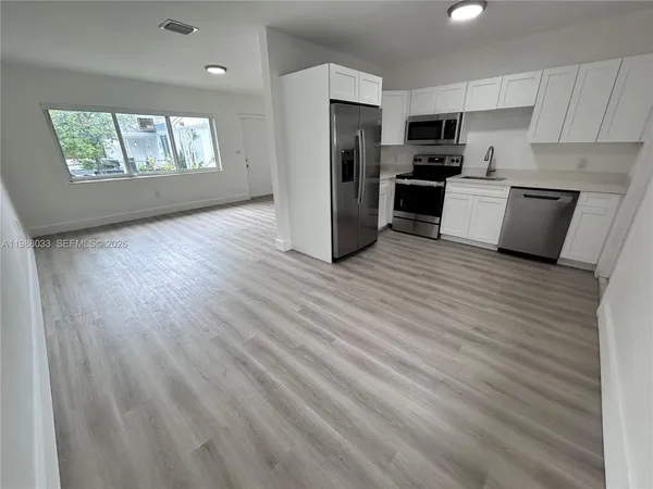 a kitchen with stainless steel appliances a refrigerator and a stove top oven