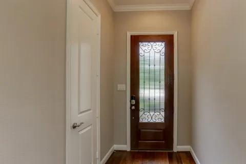 a view of front door with wooden floor