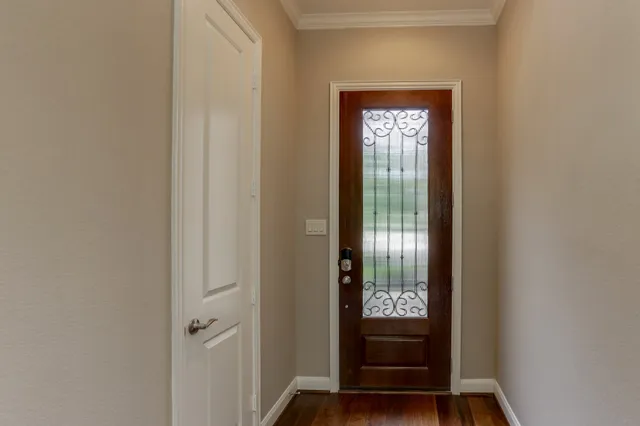 a view of front door with wooden floor