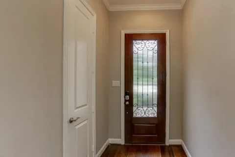 a view of an empty room and a ceiling fan and window