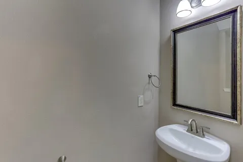a bathroom with double sink and a mirror