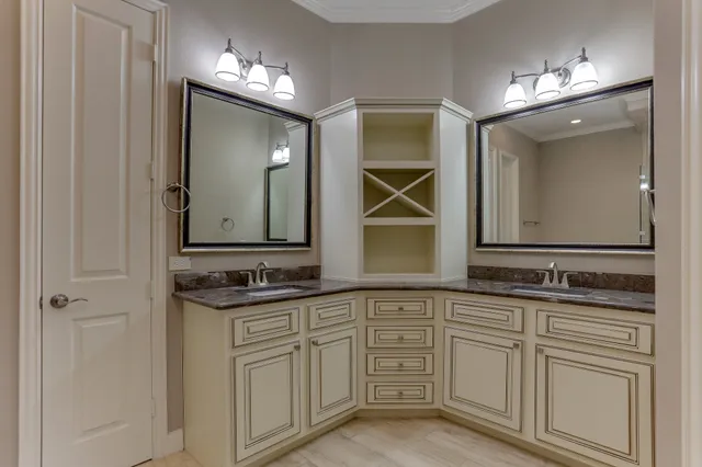 a bathroom with double sink and a mirror