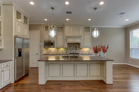 a view of kitchen with stainless steel appliances granite countertop cabinets and wooden floor