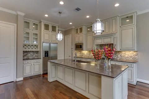 a kitchen with stainless steel appliances granite countertop a sink and refrigerator