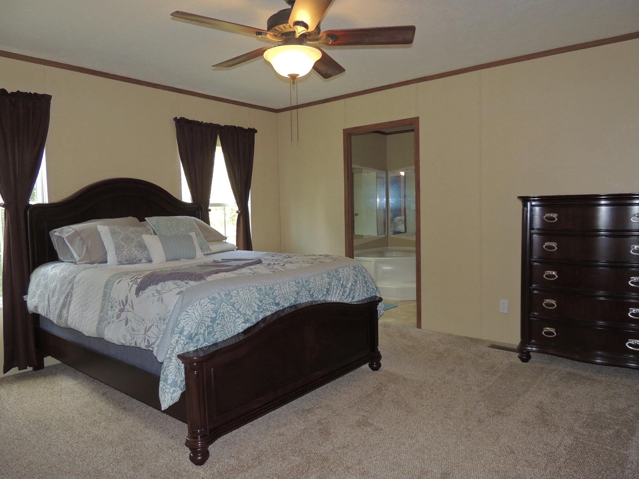 922 Arlington Ridge Road Erin, TN 37061 - Photo 13 of 18 a spacious bedroom with a bed and a ceiling fan
