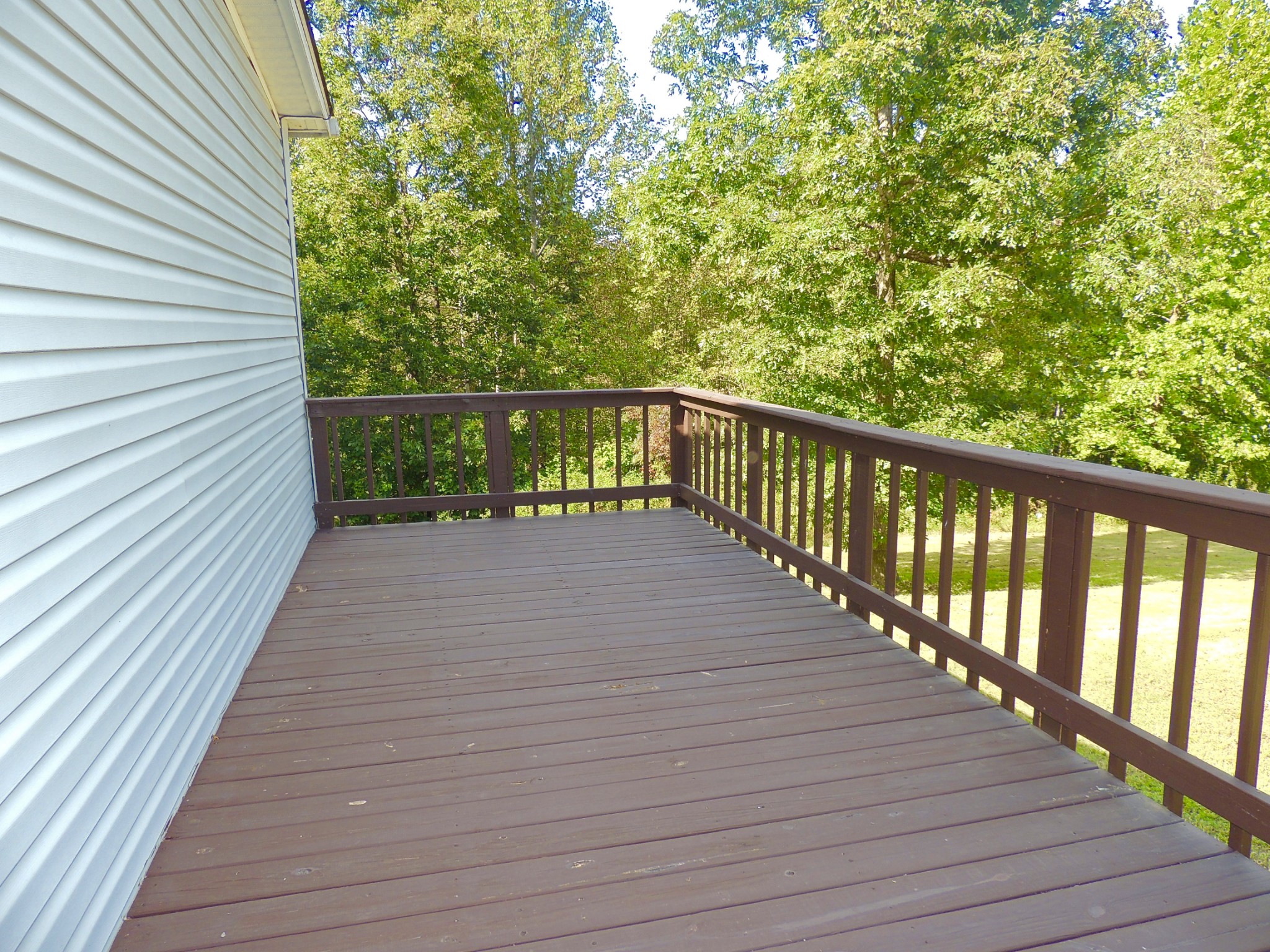 922 Arlington Ridge Road Erin, TN 37061 - Photo 5 of 18 a balcony with wooden floor and trees