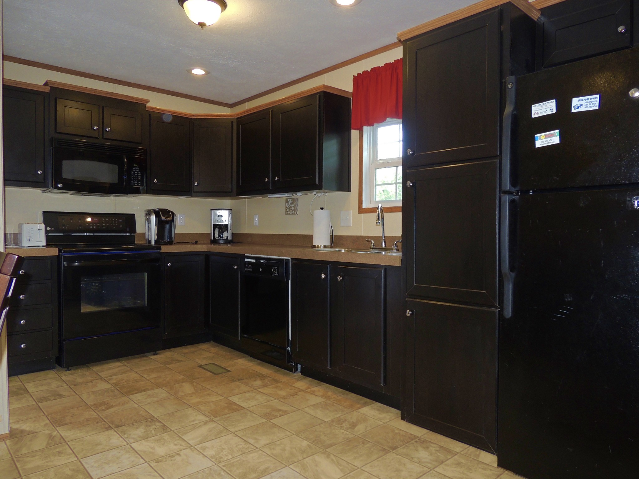 922 Arlington Ridge Road Erin, TN 37061 - Photo 7 of 18 a kitchen with stainless steel appliances granite countertop a refrigerator and a sink