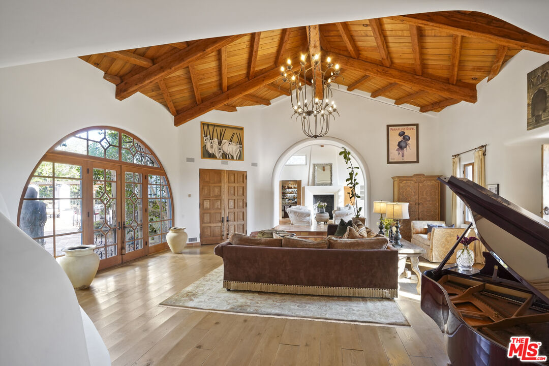 7332 Birdview Avenue Malibu, CA 90265 - Photo 11 of 71 a living room with fireplace furniture and a chandelier