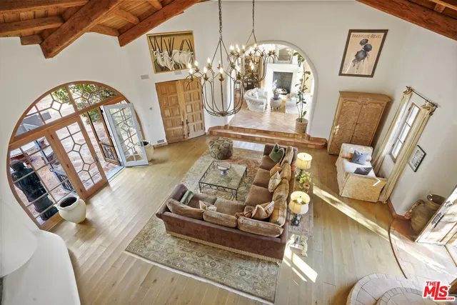 a living room with furniture and a chandelier