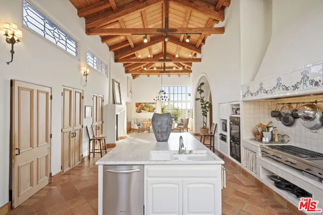 a living room with stainless steel appliances granite countertop a stove and a refrigerator