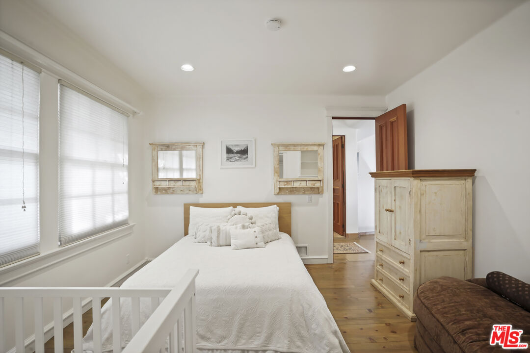 7332 Birdview Avenue Malibu, CA 90265 - Photo 26 of 71 a bedroom with a bed and wooden floor
