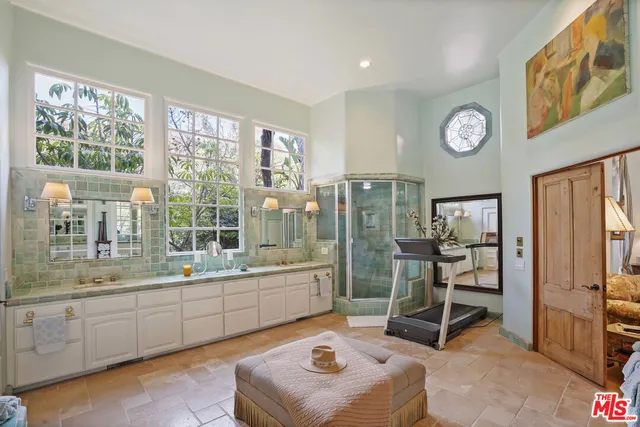 a bathroom with a granite countertop sink a large mirror and a shower