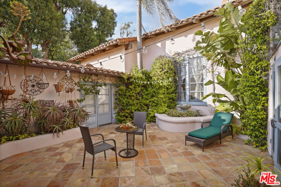 7332 Birdview Avenue Malibu, CA 90265 - Photo 34 of 71 a view of a chairs and table in backyard