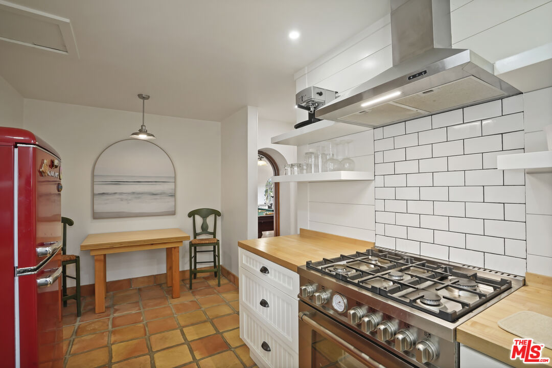 7332 Birdview Avenue Malibu, CA 90265 - Photo 41 of 71 a kitchen with granite countertop a stove and a sink