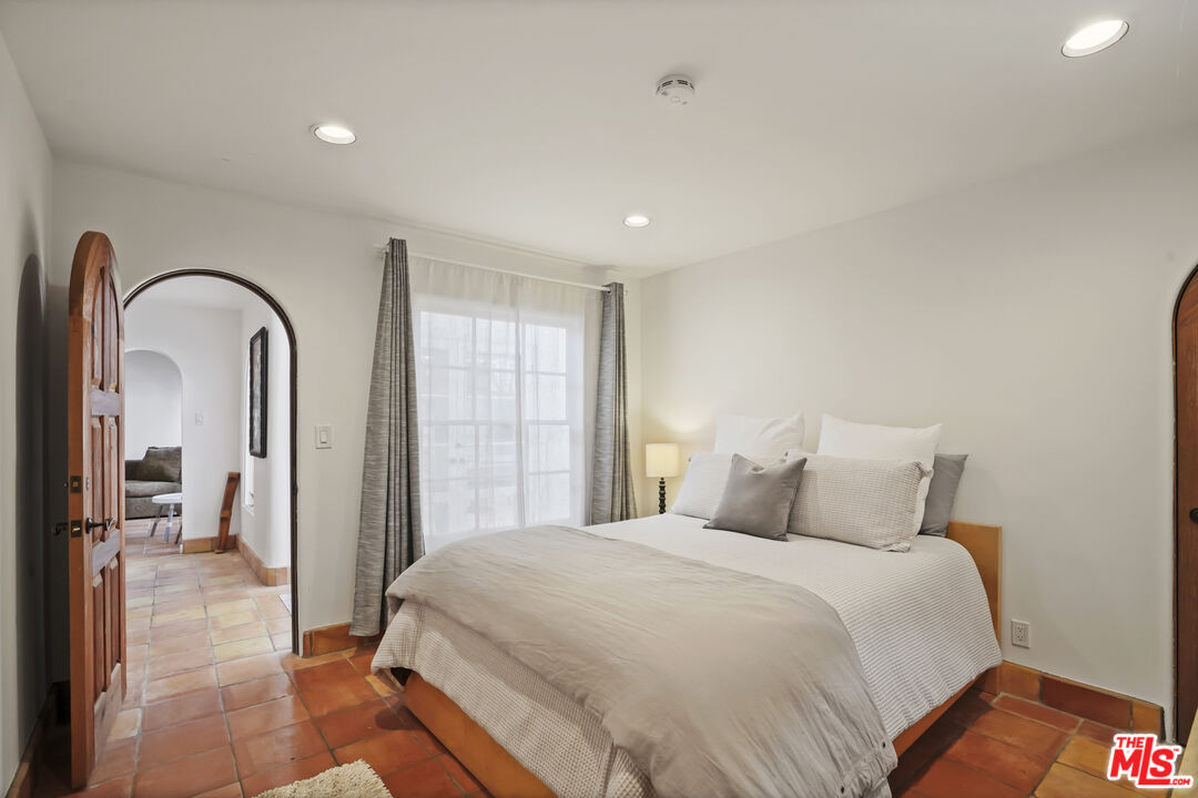 7332 Birdview Avenue Malibu, CA 90265 - Photo 43 of 71 a bedroom with a large bed and a mirror