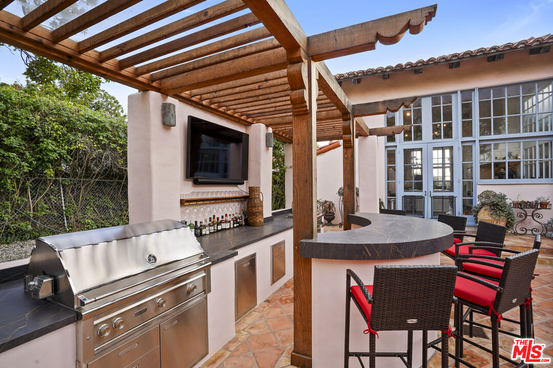 7332 Birdview Avenue Malibu, CA 90265 - Photo 46 of 71 a table and chairs in front of a house