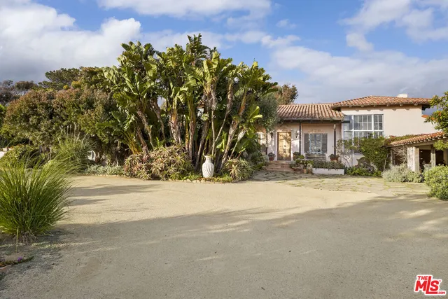 a view of a house with a tree in front