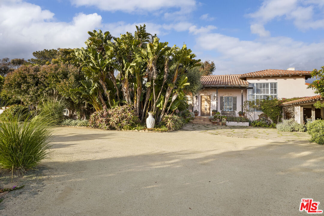 7332 Birdview Avenue Malibu, CA 90265 - Photo 7 of 71 a front view of a house with a yard and a garage