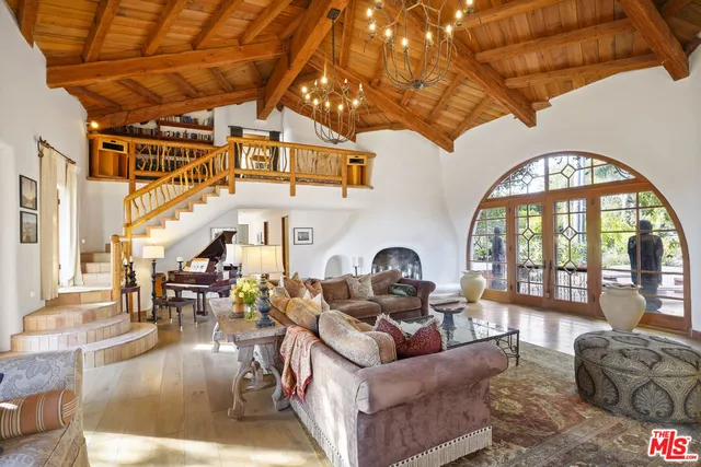 a living room with furniture a fireplace and a large window