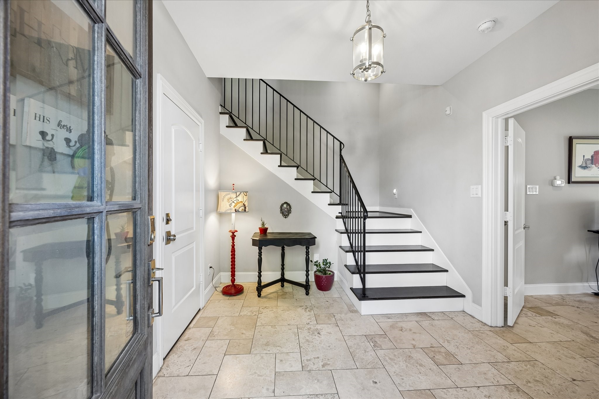 1915 Spring Street Houston, TX 77007 - Photo 3 of 40 The entry has tile flooring and opens to the stairway with its iron railing. The double doors to the right lead to the downstairs bedroom/flex room